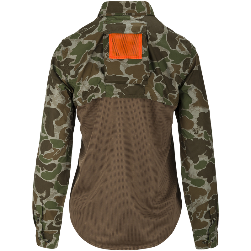 Women's Mesh Back Flyweight Shirt 2.0: A camouflage jacket with an orange patch on the back, featuring a mesh back panel for breathability. Ideal for hunting and outdoor activities.