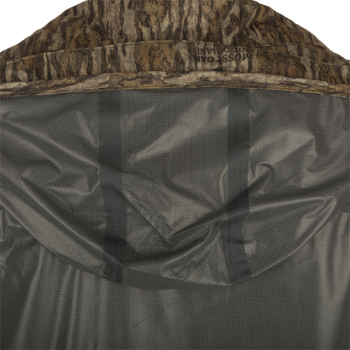 A close-up of the Ultralight Packable Rain Jacket, a waterproof/windproof jacket with a 3-piece hood, elastic closure bag, and taped seams. Perfect for staying dry during spring showers while hunting or fishing.
