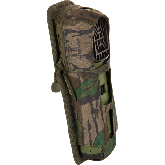 Thermacell Pouch 2.0 with Molle Attachment, featuring a camouflage design, holds a green handheld device with a vented top and visible battery pack.