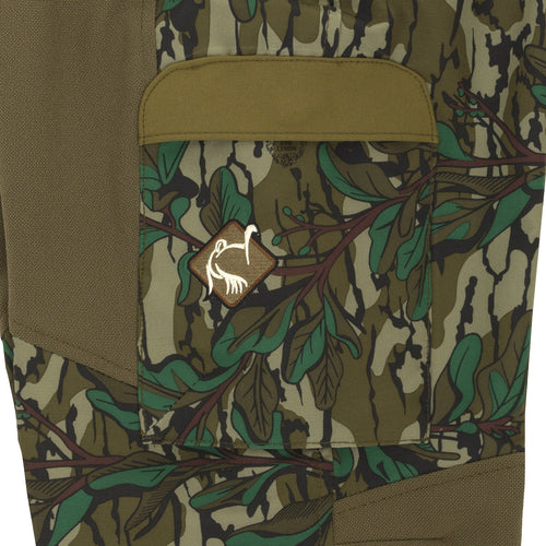 A close-up of the Women's Tech Stretch Turkey Pant, showing a pocket and a patch with a design.