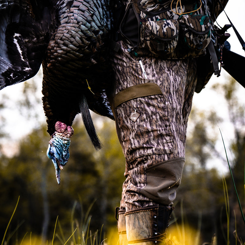 Closeup of turkey pant on hunter in outdoors setting on turkey hunt.