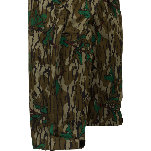 Closeup of rain pants perfect for outdoor activities. Waterproof and windproof, these pants are easily packable and fit over your outerwear. Ideal for spring showers during turkey season. From Drake Waterfowl, your go-to for high-quality hunting gear and clothing.