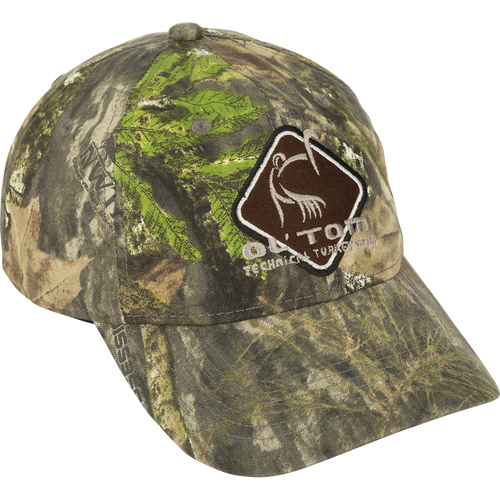 A camo cotton cap with a mid-profile fit, structured front panels, and a hook & loop back closure. Features the Ol' Tom Diamond logo.