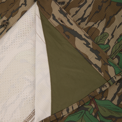 Men's Camo Wingshooter Trey Shirt with camouflage fabric, button-through flap chest pockets, hidden button-down collar, and vented cape back, ideal for hunting enthusiasts.