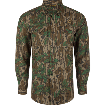 Men's Camo Wingshooter Trey Shirt with camouflage pattern, showcasing long sleeves, hidden button-down collar, chest pockets, and vented cape back for enhanced performance and comfort.