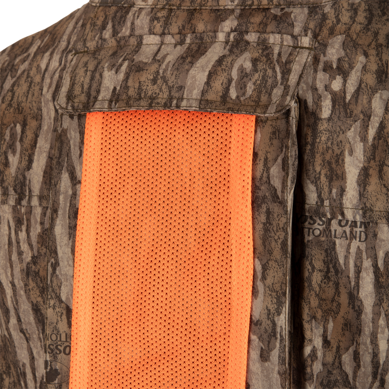 Tech 1/4 Zip with Spine Pad: A close-up of a camouflage shirt with orange mesh, featuring deep quarter-zip neck and multiple pockets.