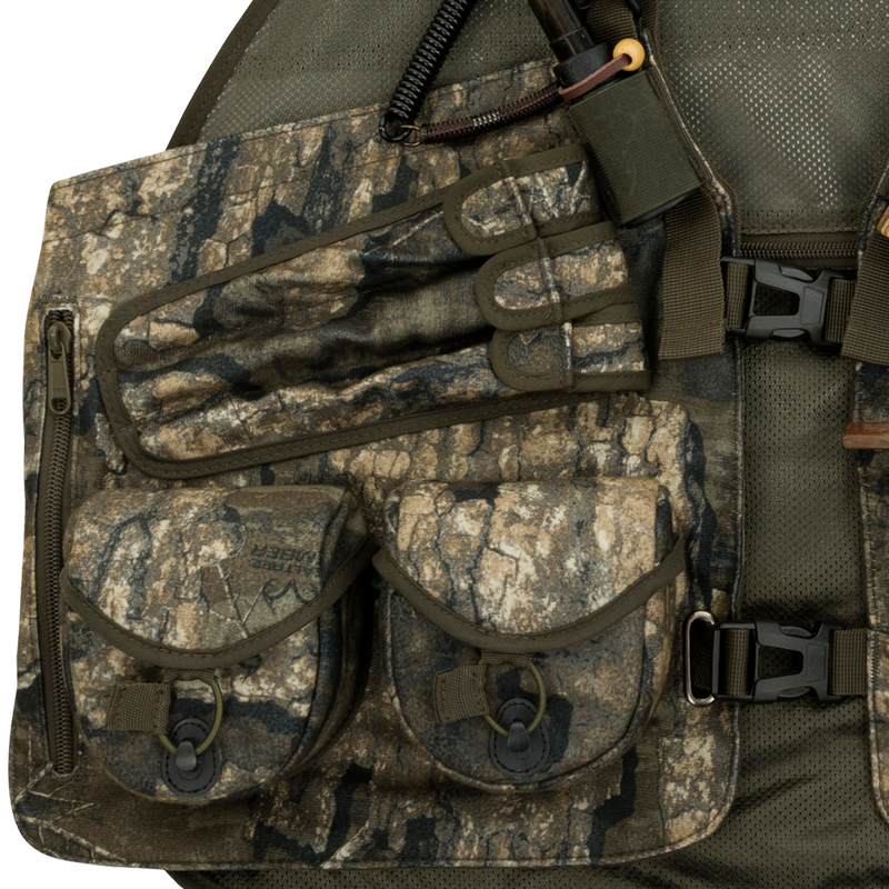 Time & Motion™ Gunslinger Turkey Vest - A close-up of a camouflaged vest with multiple pockets for calls and gear. Lightweight and well-organized for easy access.
