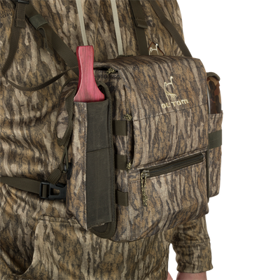 Turkey Chest Pack in camouflage, featuring multiple pockets, detachable bino harness, and a stowable rain fly, ideal for hunting trips.
