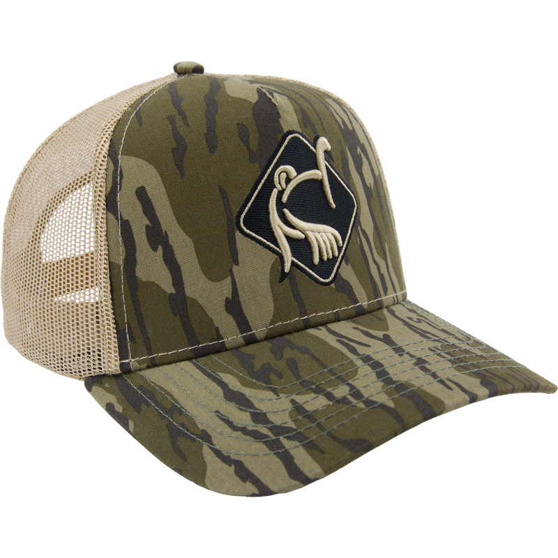 LOST Hat X Ol Tom Easy 5-Panel Trucker Cap with camo print, tan mesh, and embroidered turkey logo, offering durability and breathability for active outdoor pursuits.