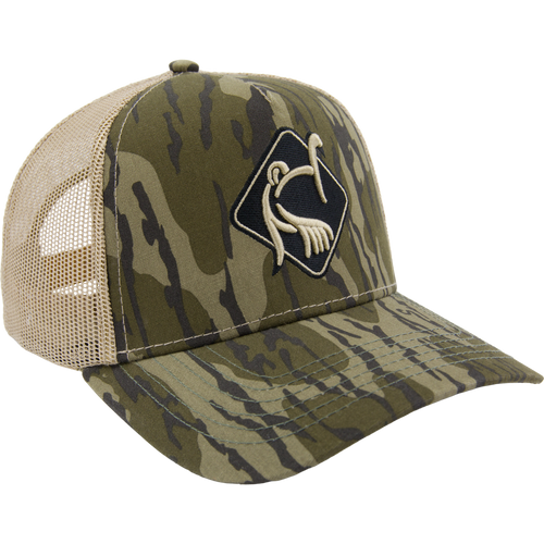 LOST Hat X Ol Tom Easy 5-Panel Trucker Cap with camo print, tan mesh, and embroidered turkey logo, offering durability and breathability for active outdoor pursuits.