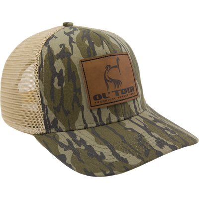 Camouflage trucker cap with tan mesh panels featuring a brown leather Ol' Tom Technical Turkey Gear patch, highlighting the LOST Hat X Ol Tom Slate Cap's functional design.