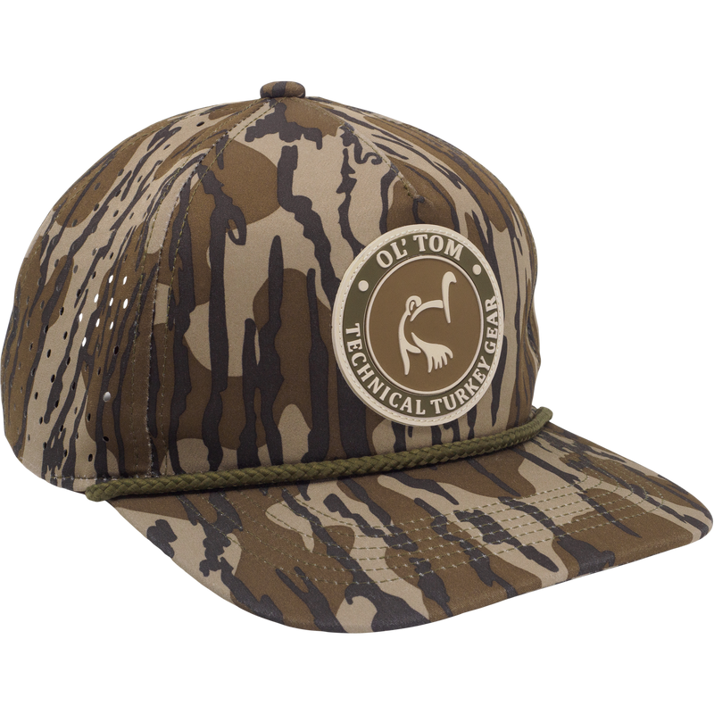 Ol' Tom Perforated Cap featuring a camo pattern with stitched rope detail and OL’ TOM • TECHNICAL TURKEY GEAR patch, ideal for hunting enthusiasts.