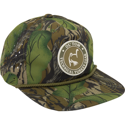 Ol' Tom Perforated Cap with camouflage pattern, rubber logo patch, braided rope detail, high crown, and laser-cut ventilation for hunting functionality.