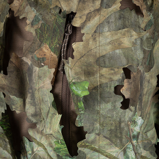 3D Leafy Pant: Close-up of a lightweight, breathable jacket with a leafy pattern cutout for turkey hunting. Zippered pass-through pockets for easy access.