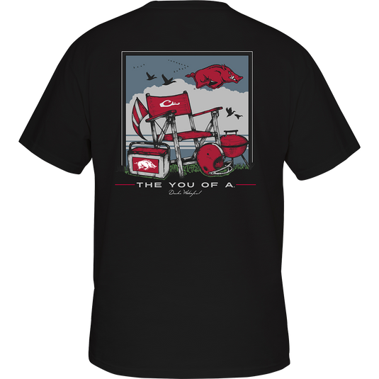 Back of a black t-shirt featuring a pig and a barbecue grill, with a beach scene and school logo. Perfect for game day at the beach.