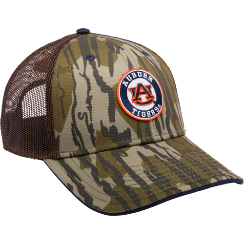 Auburn Bottomland Mesh Back Cap featuring Mossy Oak Bottomland Camo pattern. 6-panel trucker cap with embroidered college logo, X-Peak visor, and adjustable snap-back closure. Ideal for hunting and outdoor enthusiasts.