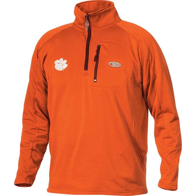 Clemson Breathelite™ 1/4 Zip: An orange jacket with a white paw print logo, perfect for active outdoorsmen. Made of 100% polyester with 4-way stretch and square check fleece backing. Features a vertical front chest zippered pocket.