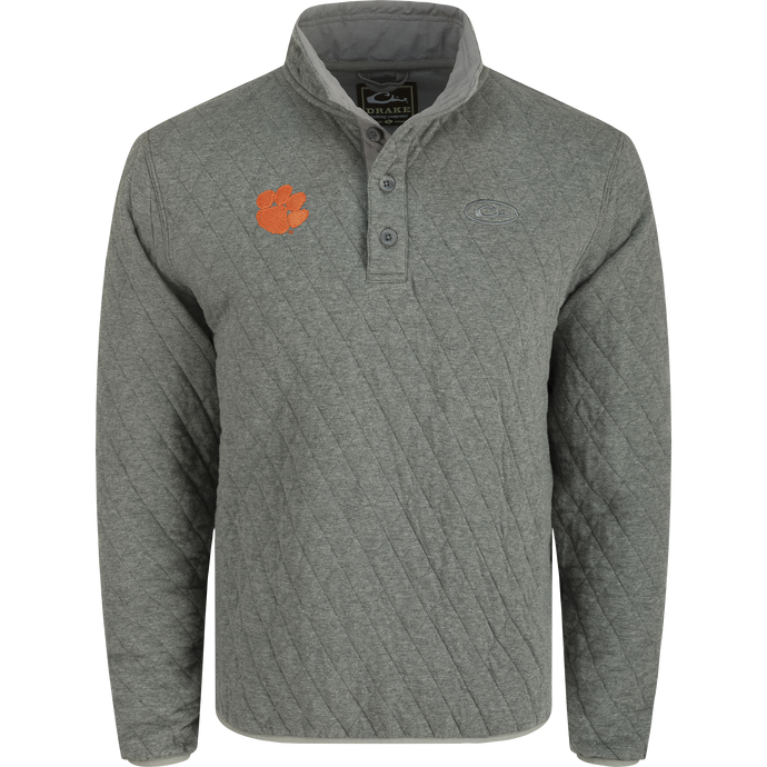 Clemson Delta Quilted 1/4 Snap Sweatshirt: A midweight, brushed cotton sweatshirt with a polyester fill diamond quilting for added warmth. Features a team logo and elastic cuff and hem. Perfect for cool Autumn days.