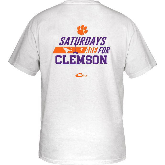 Clemson Saturdays T-Shirt: Back of white shirt with stylized purple and orange text featuring school's name and logo. Front showcases school's logo on chest pocket.