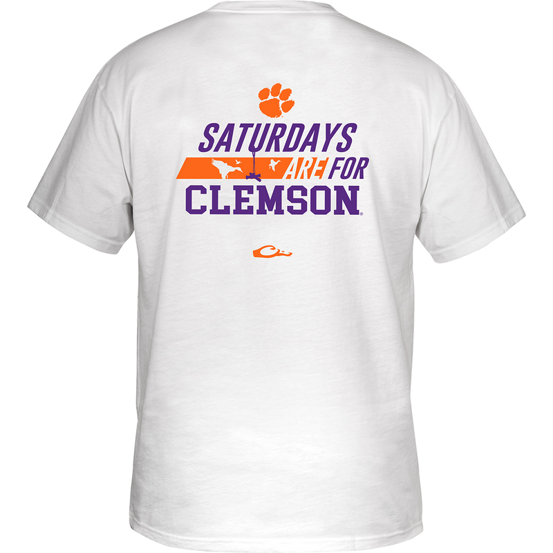 Clemson Saturdays T-Shirt: Back of white shirt with stylized purple and orange text featuring school's name and logo. Front showcases school's logo on chest pocket.