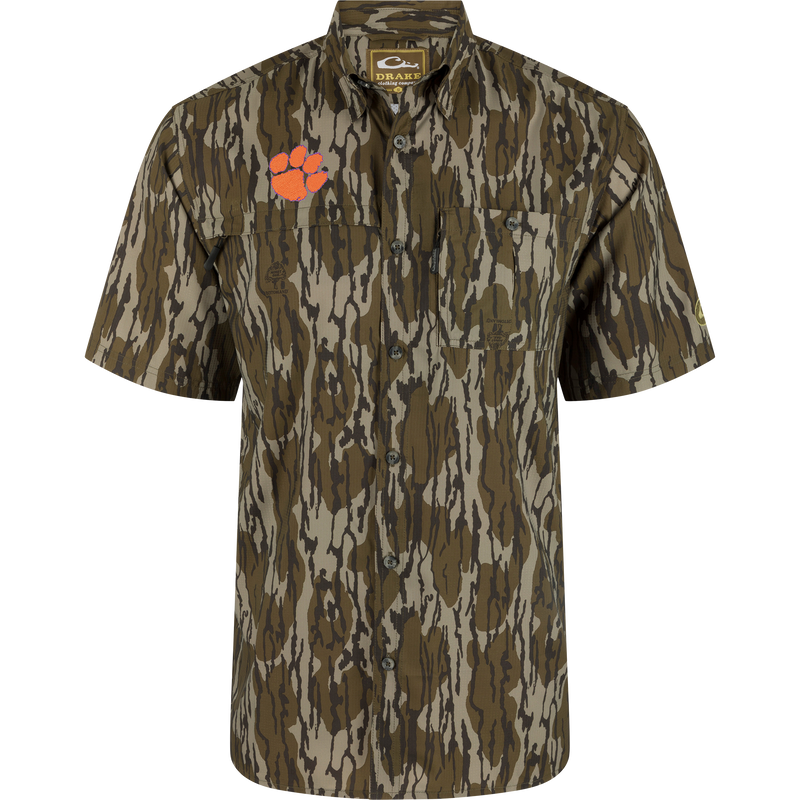 Clemson 8-Shot Short Sleeve Shirt with woodland camo, dual chest pockets, and orange paw-print logo, offering UPF 30 protection with moisture-wicking and quick-drying features.