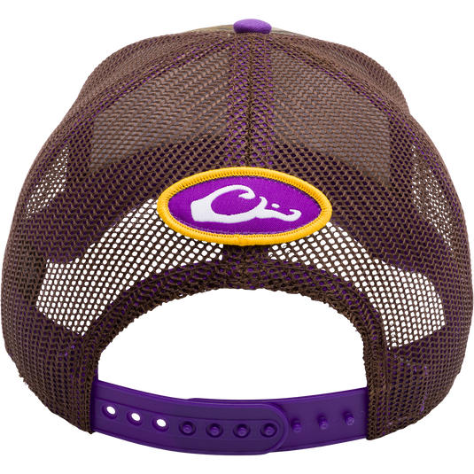 LSU Bottomland Mesh Back Cap: A purple and yellow trucker hat featuring Mossy Oak Bottomland Camo pattern, 3D embroidered college logo, and adjustable snap-back closure. Ideal for hunting and outdoor enthusiasts.