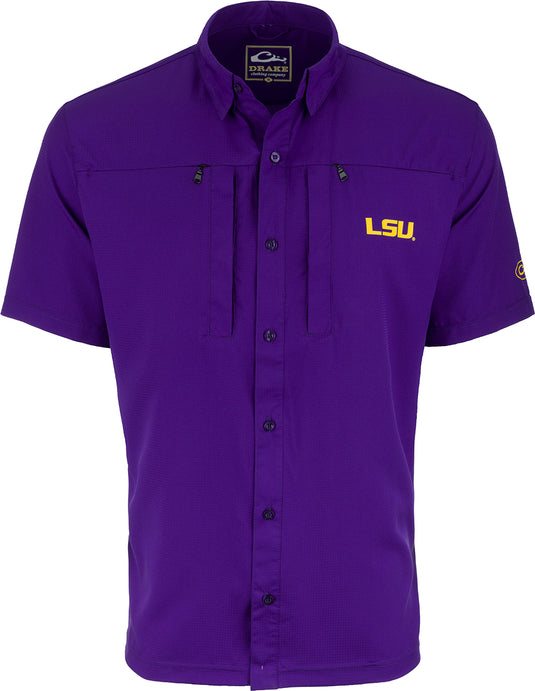 LSU S/S Performance Stretch Button Up: A purple shirt with a yellow logo, featuring a half-button design, zippered chest vents, and hidden button pockets. Made with woven fabric, four-way stretch performance fabric backing, and four-way stretch mesh sides and underarms. Innovative design combines style, comfort, and functionality for practical solutions. Perfect for big game hunting, waterfowl hunting, turkey hunting, and fishing.