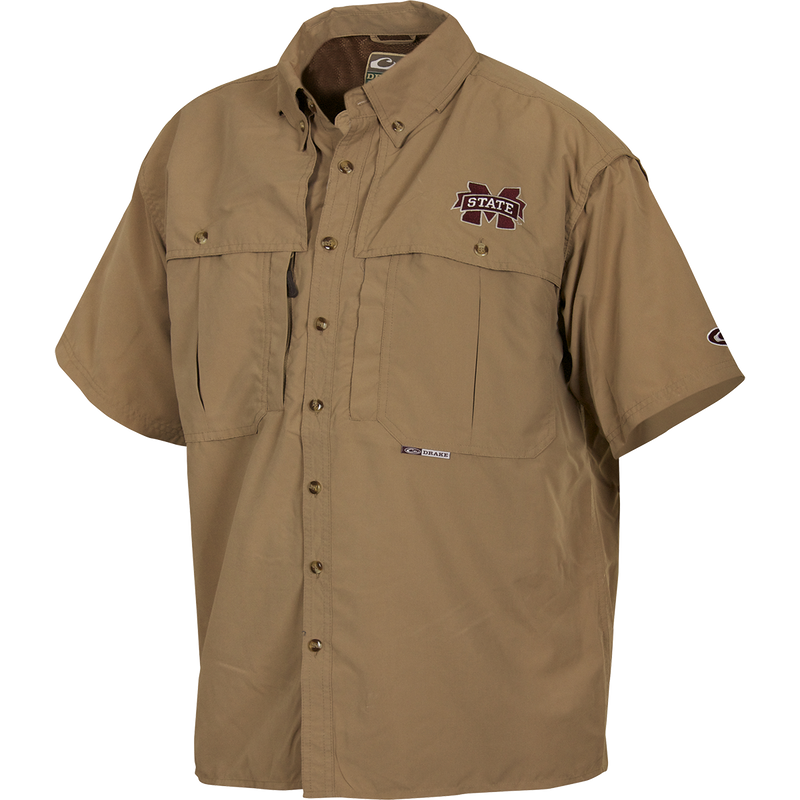 A Mississippi State Wingshooter's Shirt S/S, featuring a logo, short sleeves, and a button design. Breathable and quick-drying with front and back ventilation. Functional with oversized chest pockets and a zippered pocket. Perfect for Game Day.