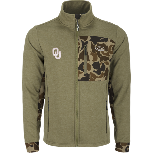 Oklahoma Hybrid Windproof Jacket featuring camouflage design, windproof laminate, fleece lining, 4-way stretch cuffs, and zippered pockets. Ideal for cool days, perfect for hunting and outdoor activities.