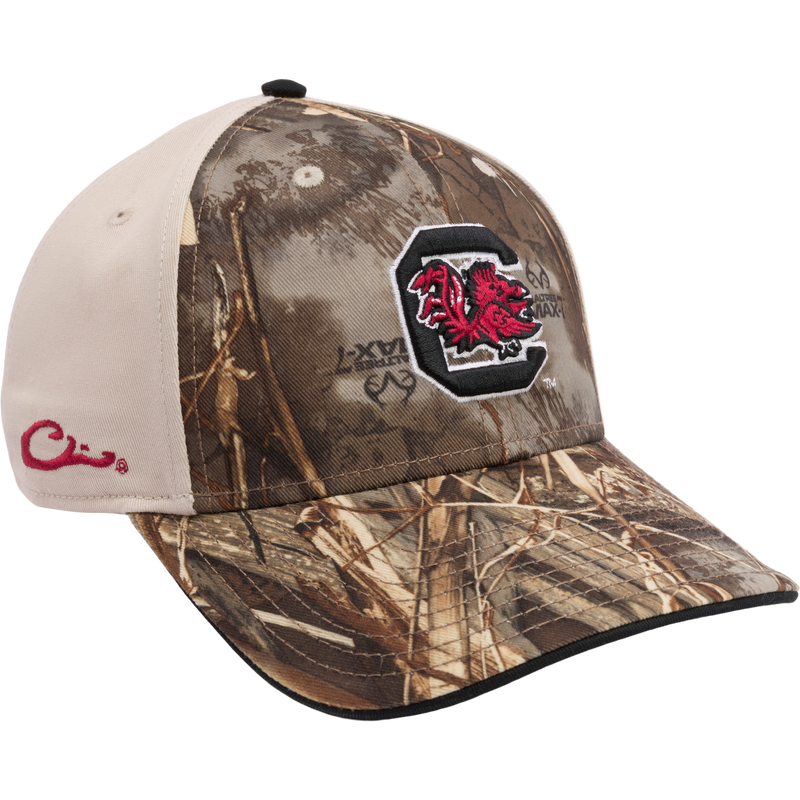 Structured South Carolina Max-7 Twill Cap with Realtree Max 7 Camo pattern. Features 3D embroidered college logo, X-Peak visor, and adjustable closure. Ideal for hunting and casual wear from Drake Waterfowl.
