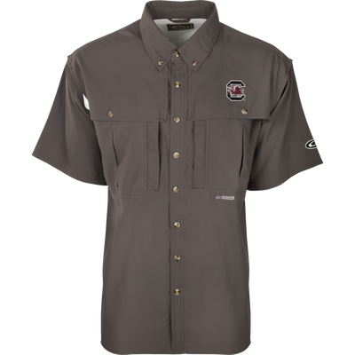 South Carolina S/S Flyweight Wingshooter: A grey shirt with a logo, designed for warm-weather outdoor activities. Features include vented back design, quick-drying fabric, UPF 50+ sun protection, and multiple pockets.