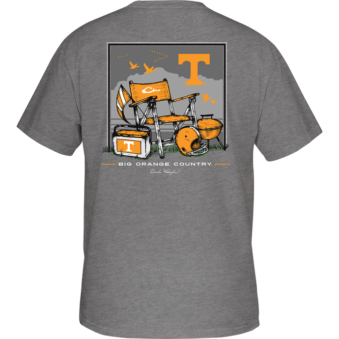 Tennessee Beach T-Shirt: Back of a grey t-shirt with a beach scene featuring a bench, flag, and a helmet. Front showcases the school's logo on the chest pocket.