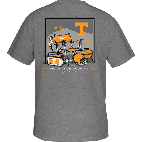 Tennessee Beach T-Shirt: Back of a grey t-shirt with a beach scene featuring a bench, flag, and a helmet. Front showcases the school's logo on the chest pocket.