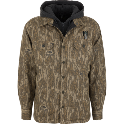 Spoonie Campfire Hoodie, a long-sleeved button-up shirt in a Mossy Oak Bottomland camouflage pattern with a built-in dark gray hooded sweatshirt, serving as an insulated hunting hoodie.