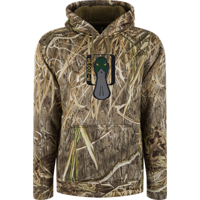 Spoonie Silencer Hoodie in a grass and reed camouflage pattern, featuring a heavyweight fleece construction, a stylized green-headed duck logo on the chest, and a kangaroo pocket.