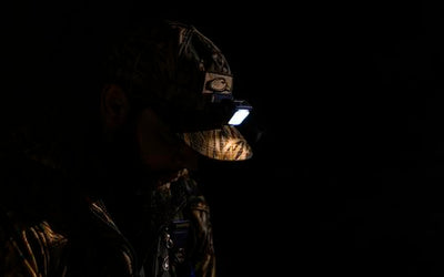 Man in dark area wearing headlamp.