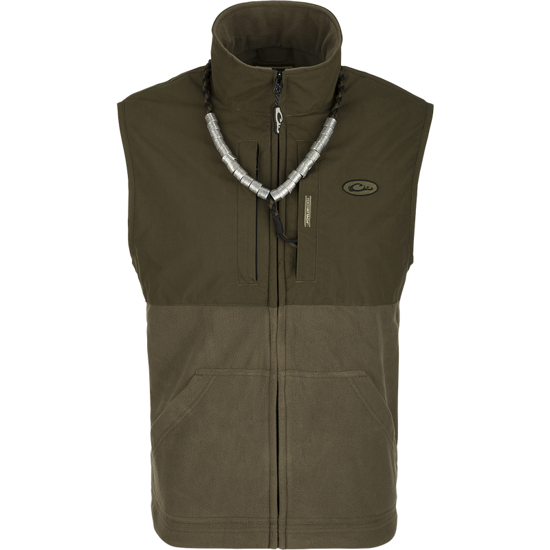 MST Eqwader Vest: A versatile green and grey vest with a silver necklace. Features include waterproof protection, fleece-lined upper body, and multiple pockets for storage. Ideal for hunting and outdoor activities.