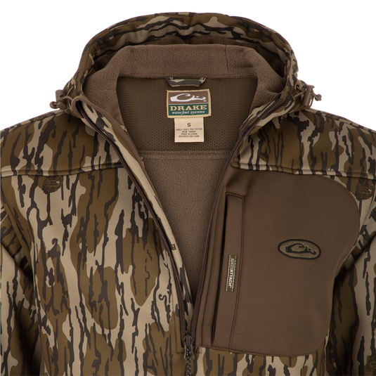A khaki MST Endurance Hoodie with a zipper, featuring a Magnattach™ chest pocket, kangaroo pouch, and fleece-lined hood. Made of high-gauge, breathable Endurance fabric for maximum comfort and mobility. Ideal for warmer conditions.