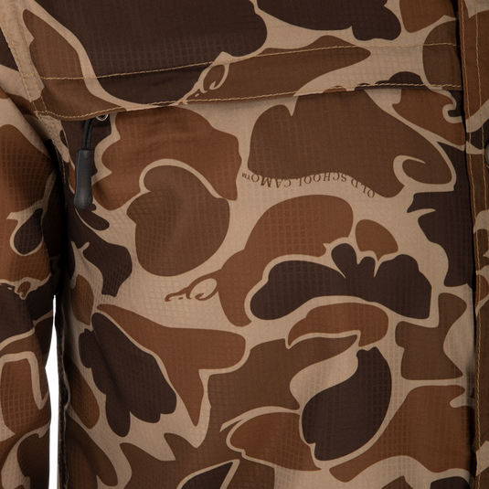 A close-up of the Drake 8-Shot Flyweight S/S Shirt, featuring the exclusive Old School Camo pattern. Lightweight Dobby fabric with built-in stretch, UPF 30 sun protection, and moisture-wicking properties. Classic fit with hidden button-down collar and vented cape back.