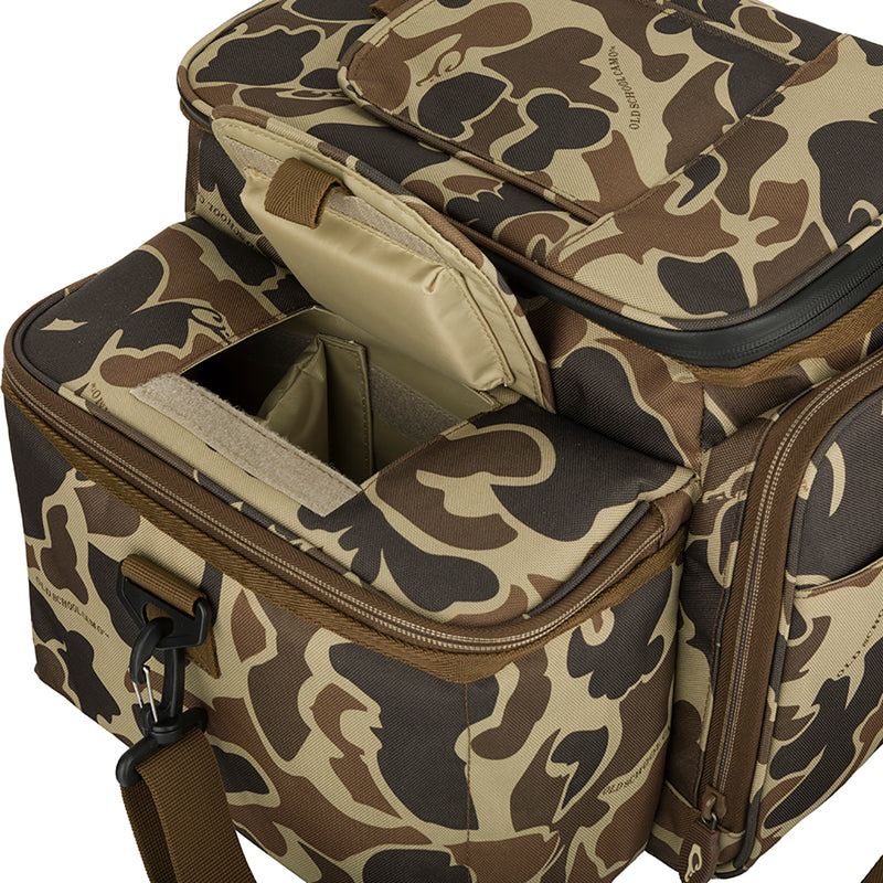 A camouflage bag with a zipper, perfect for carrying essentials and hydration into the dove field. Features a 12-Can/Bottle cooler compartment to keep water cool, a quick-access flap for grabbing shells, and a removable mesh game bag for holding birds. Wingshooter's Shell Boss.