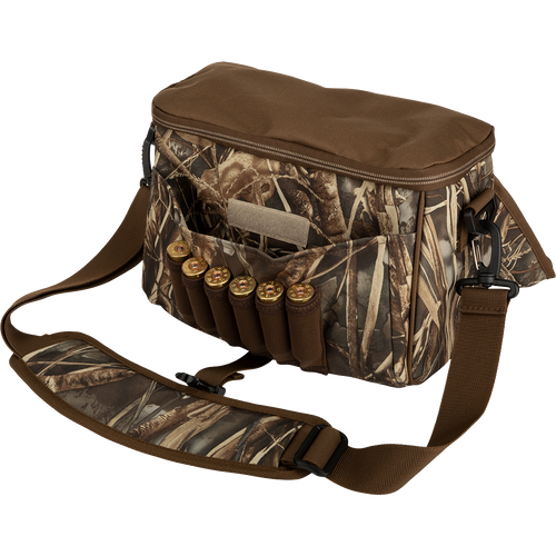 Alt text: A rugged Refuge Blind Bag with bullets and cartridges, featuring adjustable strap, neoprene shell loops, and durable hardware, ideal for daily waterfowl hunting.