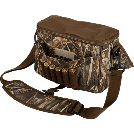 Alt text: A rugged Refuge Blind Bag with bullets and cartridges, featuring adjustable strap, neoprene shell loops, and durable hardware, ideal for daily waterfowl hunting.