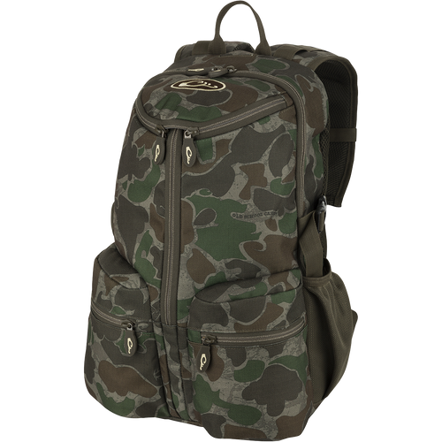 A compact and functional Vertical Zip Daypack, perfect for hunting or everyday use. Features include padded shoulder straps, large interior storage, external carry straps, and hydration bladder compartment. Made with 100% Polyester Rugged HD2™ Material and Drake’s Fowl-Proof™ YKK Zippers. Dimensions: 18.5
