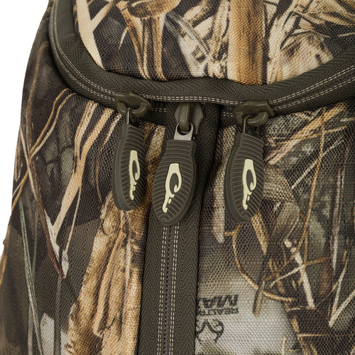 A close-up of the Vertical Zip Daypack, a rugged backpack with multiple storage compartments, padded shoulder straps, and external carry straps. Ideal for hunting, travel, or everyday use.