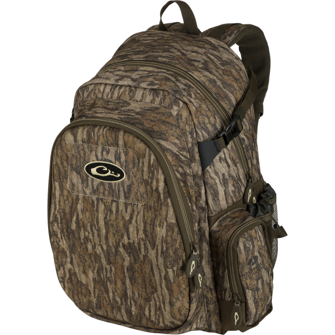 A rugged, PVC-backed Hardshell Every Day Pack with a camouflage pattern. Features include a protected outer compartment, sunglasses pouch, and adjustable straps. Ideal for day trips, travel, or everyday use.