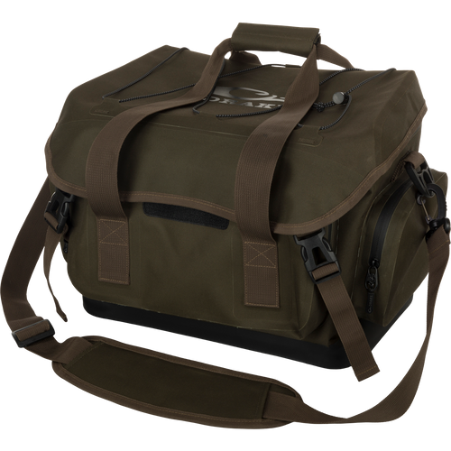 HND Blind Bag: Waterproof green bag with straps. Features large storage area, exterior pockets with waterproof zippers, and customizable organization. Perfect for hunting and outdoor activities.