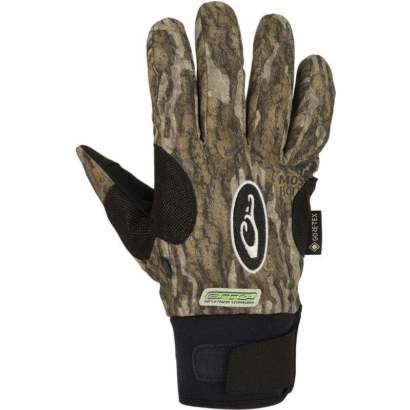 A waterproof glove for early season hunting. EST Refuge HS GORE-TEX Gloves with a black and green design. Features include a digitized goat skin leather palm and gusseted neoprene cuffs. Stay-Put™ liner system prevents twisting and bunching. Adjustable gusset Velcro cuff closure for a secure fit. Pull loop assist for easy glove on/off.