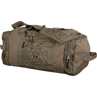 A durable Duffle Bag designed for outdoor adventures. Made of rugged polyester fabric with oversized zippers. Features a large center compartment, two end pockets, and a small front accessory pocket. Adjustable padded shoulder straps for comfort. Available in Medium and Large sizes.