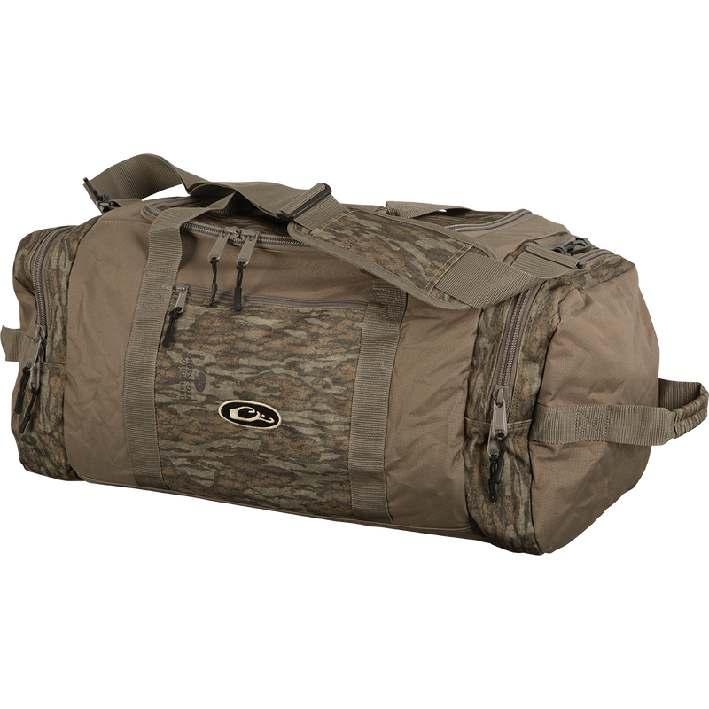 A durable Duffle Bag designed for outdoor adventures. Made of rugged polyester fabric with oversized zippers. Features a large center compartment, two end pockets, and a small front accessory pocket. Adjustable padded shoulder straps for comfort. Available in Medium and Large sizes.
