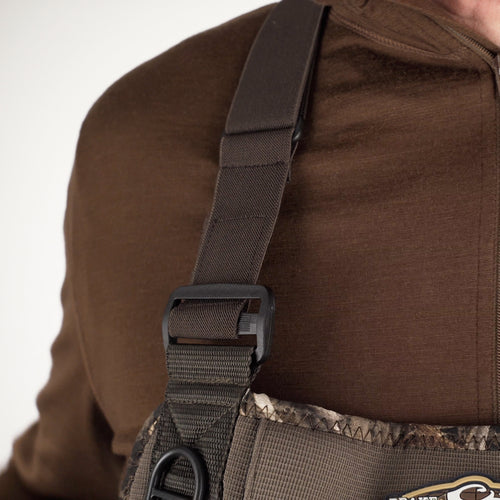 A person wearing a brown shirt and a black belt, showcasing the Buckshot Eqwader 1600 Neoprene Wader 3.0.